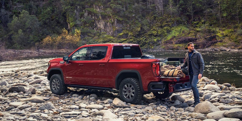 GMC Sierra 1500 on rocky riverbank outdoor